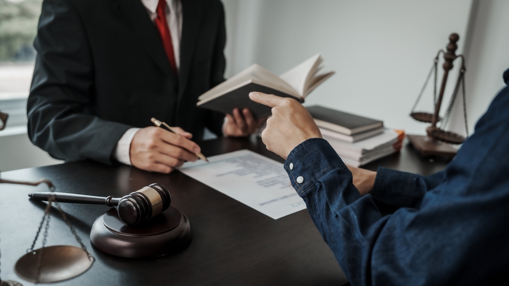 A client discussing a civil dispute with a lawyer in a modern office