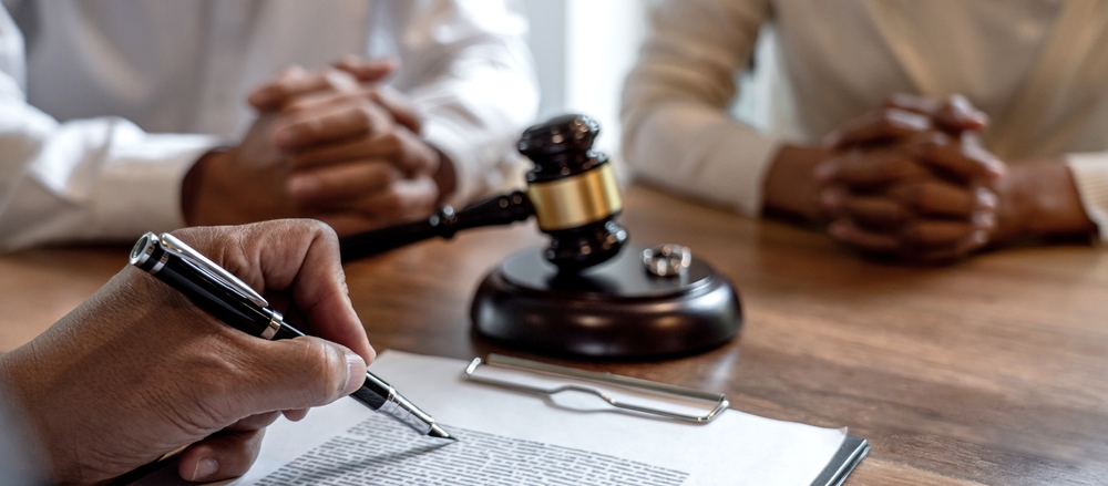 A separated couple in a lawyer’s office during a serious but calm legal consultation